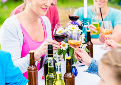 Friends celebrating small garden party clinking glasses